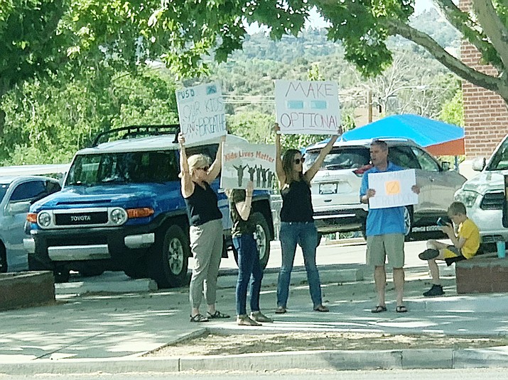 A few parents stand outside the Prescott Unified School District on Tuesday, June 1, 2021, to protest masks being required on the district’s campuses due to COVID-19. District officials are planning to lift the restriction potentially by next school year. (Rebecca Horniman/Courtesy)