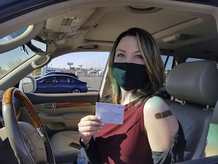 Emily Alexander, 37, shows her COVID-19 vaccination card shortly after getting the vaccine in the parking lot of the State Farm Stadium in Glendale, Ariz., on Jan. 11, 2021. The state's top health official said Arizona may not meet the president's goal of getting 70% of residents vaccinated against the coronavirus by July 4. (Terry Tang/AP, file)