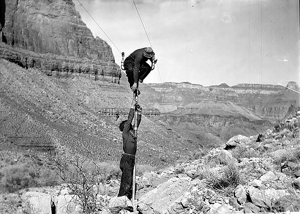 TRANS-CANYON TELEPHONE LINE CONSTRUCTION -  2 CCC ENROLLEES ATTACHING WIRE TO POLE BELOW THE REDWALL & NEAR INDIAN GARDENS. ONE MAN IS BALANCING  AT THE TOP OF THE POLE..CIRCA 1935. NPS PHOTO BY ED LAWS. GRAND CANYON NATIONAL PARK MUSUEM COLLECTION, P.O. BOX 129, GRAND CANYON, AZ 86023..