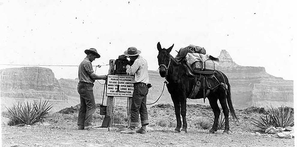 MEN WORKING ON AN EMERGENCY PHONE ON THE S KAIBAB TRAIL, TONTO PLATEAU. DETAIL OF INSTRUCTIONAL SIGN. CIRCA 1937. NPS PHOTO GRAND CANYON NATIONAL PARK MUSUEM COLLECTION, P.O. BOX 129, GRAND CANYON, AZ 86023