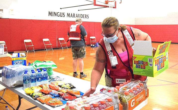 American Red Cross volunteer Candy Kuhn sets out snacks in Mingus Union High School’s small gym Sunday evening. Only a handful of Cornville-area residents had shown up at the quickly-established shelter at the school as of Sunday evening, though the “go” order remained in place for a significant portion of Cornville. VVN/Jason W. Brooks
