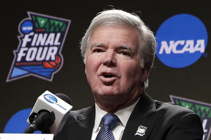 In this April 4, 2019, photo, NCAA President Mark Emmert answers questions at a news conference at the Final Four college basketball tournament in Minneapolis. Emmert told the organization's more than 1,200 member schools Friday, June 18, 2021, that he will seek temporary rules as early as July to ensure all athletes can be compensated for their celebrity with a host of state laws looming and congressional efforts seemingly stalled.  (Matt York/AP, File)