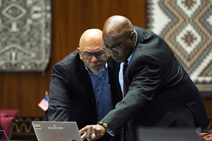 Rep. Diego Espinoza, D-Tolleson, left, looks at a computer with Rep. Walter Blackman, R-Snow Flake, during a vote on the Arizona budget Thursday, June 24, 2021, in Phoenix. (AP Photo/Ross D. Franklin)