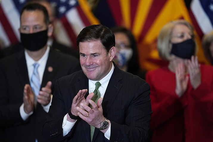 This April 15, 2021 photo shows Gov. Doug Ducey at the Heard Museum in Phoenix. Ducey signed legislation putting in place an immediate $1.3 billion tax cut, set to rise to $1.9 billion, that is designed largely to benefit the most wealthy. (Ross D. Franklin/AP, file)