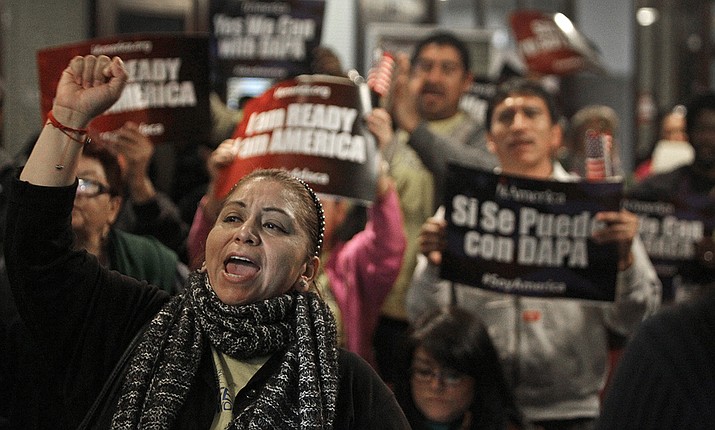 In this  Tuesday, Feb. 17, 2015 file photo, Mercedes Herrera and others chant during an event on DACA and DAPA Immigration Relief at the Houston International Trade Center in Houston. A federal judge in Texas on Friday, July 16, 2021 ordered an end to an Obama-era program that prevented the deportations of some immigrants brought into the United States as children, putting new pressure for action on President Joe Biden and Democrats who now control Congress. (Melissa Phillip/Houston Chronicle via AP, File)