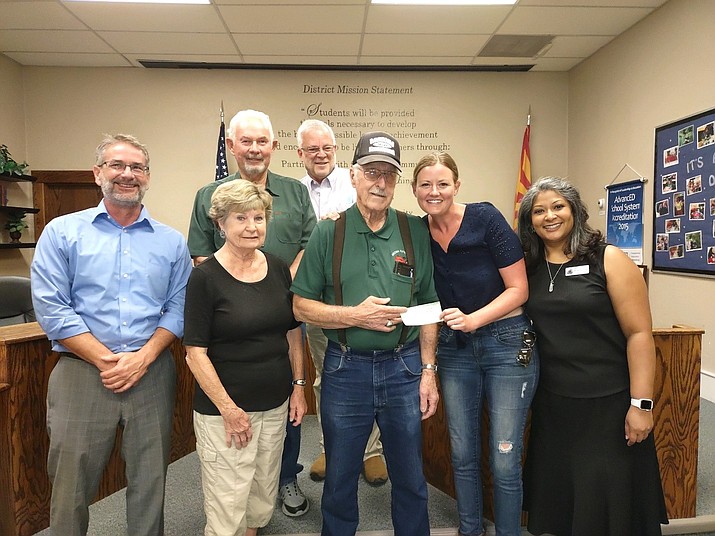 Arizona Flywheeler President Gary Covert, accompanied by members Ginny and Steve Rench, donated a check for $1,000 on Tuesday, July 13, 2021, to support the purchase of a High Tunnel Greenhouse for the Oak Creek School agriculture program garden. In photo are, front row: Superintendent Steve King, Ginny Rench, Gary Covert, Lyndsay Ludden, Naya Persaud. Back row: Steve Rench and Tom Coultas. “We like to support local agricultural school programs in line with our club’s purpose,” Covert said. Accepting the donation was Lyndsay Ludden, agricultural education teacher accompanied by Principal Naya Persaud. In addition, the Flywheelers presented Persaud (on behalf of the four K-8 schools) new U.S. and Arizona flags for the coming school year. (Arizona Flywheeler/Courtesy)