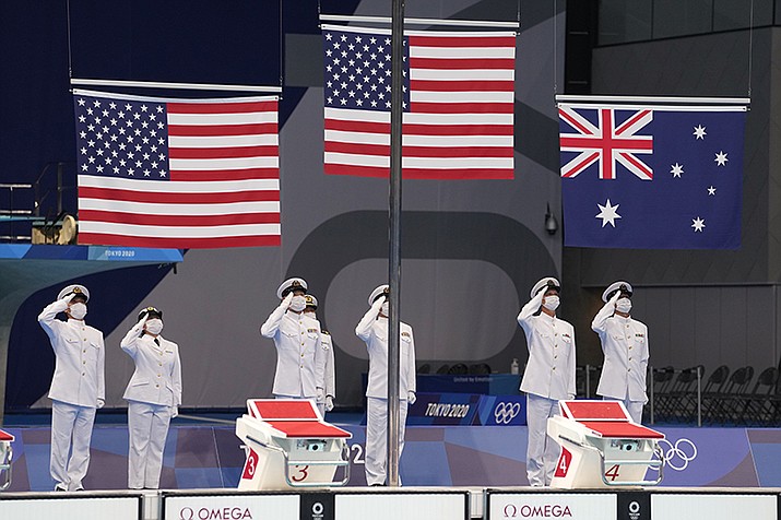 The flags are raised for the medal ceremony for the men's 400 meter individual medley at the 2020 Summer Olympics, Sunday, July 25, 2021, in Tokyo, Japan. (Martin Meissner/AP)