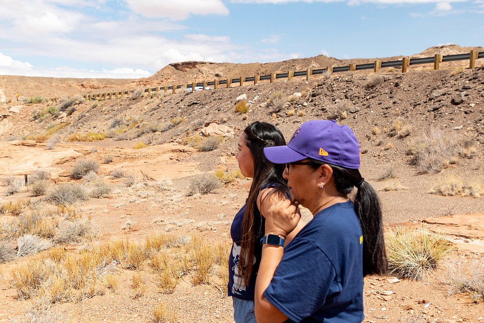 Former Miss Hopi Mikaela Gamble along with her mother Shelly Hongeva watch the flooding with concern from a cliff side vantage point July 25. (Gilbert Honanie/NHO)