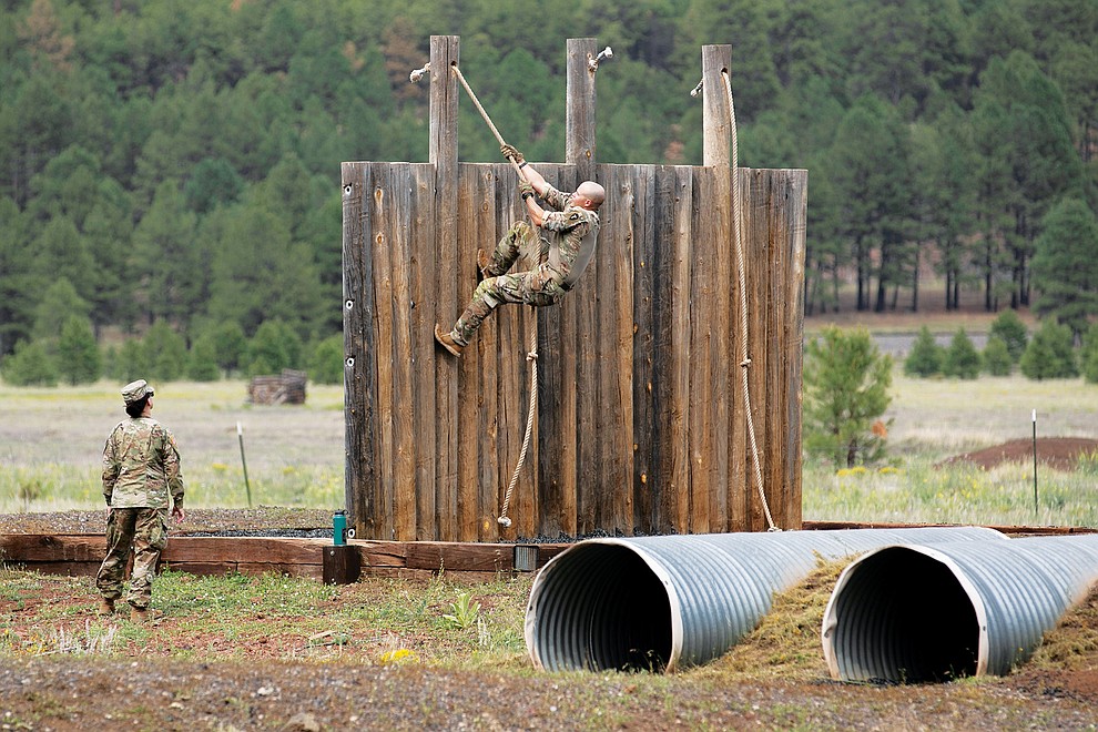 Spc. Addison Smith, a Cavalry Scout with A-Troop, 1-112th Cavalry Regiment, Texas Army National Guard, runs up the rope wall at the confidence course during the 2021 Army National Guard Best Warrior Competition at Camp Navajo Military Reservation, Ariz., July 21, 2021. The competition spans three physically and mentally demanding days where competitors are tested on a variety of tactical and technical skills as they vie to be named the Army Guard’s Soldier and Noncommissioned Officer of the Year. The winners then represent the Army Guard in the Department of the Army Best Warrior Competition later this year (US Army photo by Staff Sgt. Richard Hoppe).