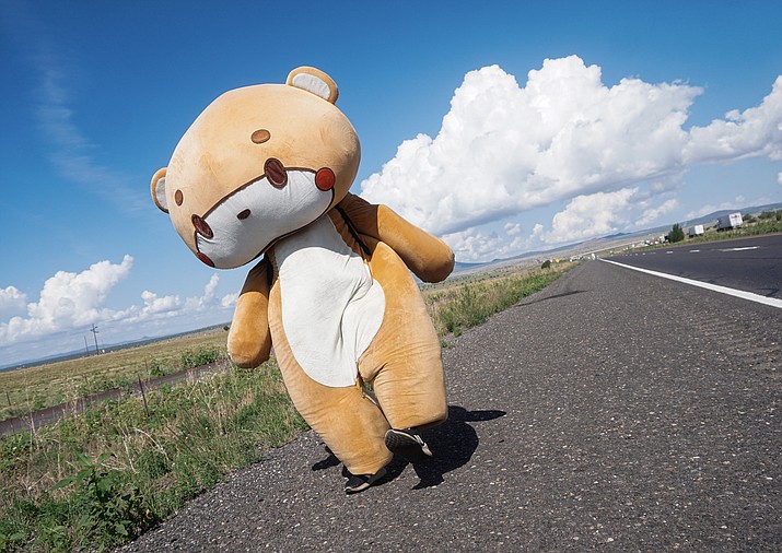 Jessy Larios of California dons his bear costume, which he refers to as “Bearnsun,” while walking east on Interstate 40 near Ash Fork on Tuesday, July 27, 2021. This year, Larios has garnered a significant social media following by starting his own campaign that has him walking from Los Angeles to New York City in his costume to raise money for charity. (Aaron Valdez/Courier)