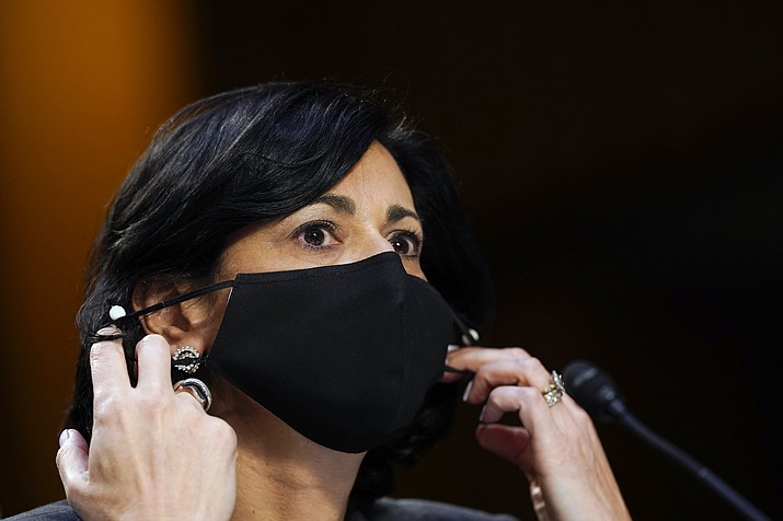 Dr. Rochelle Walensky, director of the Centers for Disease Control and Prevention, adjusts her face mask during a Senate Health, Education, Labor and Pensions Committee hearing on the federal coronavirus response on Capitol Hill in Washington, in this Thursday, March 18, 2021, file photo. Walensky says new mask-wearing guidance, coupled with higher rates of vaccination against COVID-19, could halt the current escalation of infections in “a couple of weeks.” The director of the Centers for Disease Control and Prevention told “CBS This Morning” she hopes more stringent mask-wearing guidelines and other measures won’t be necessary as the country heads into the fall. (Susan Walsh/AP, Pool, File)