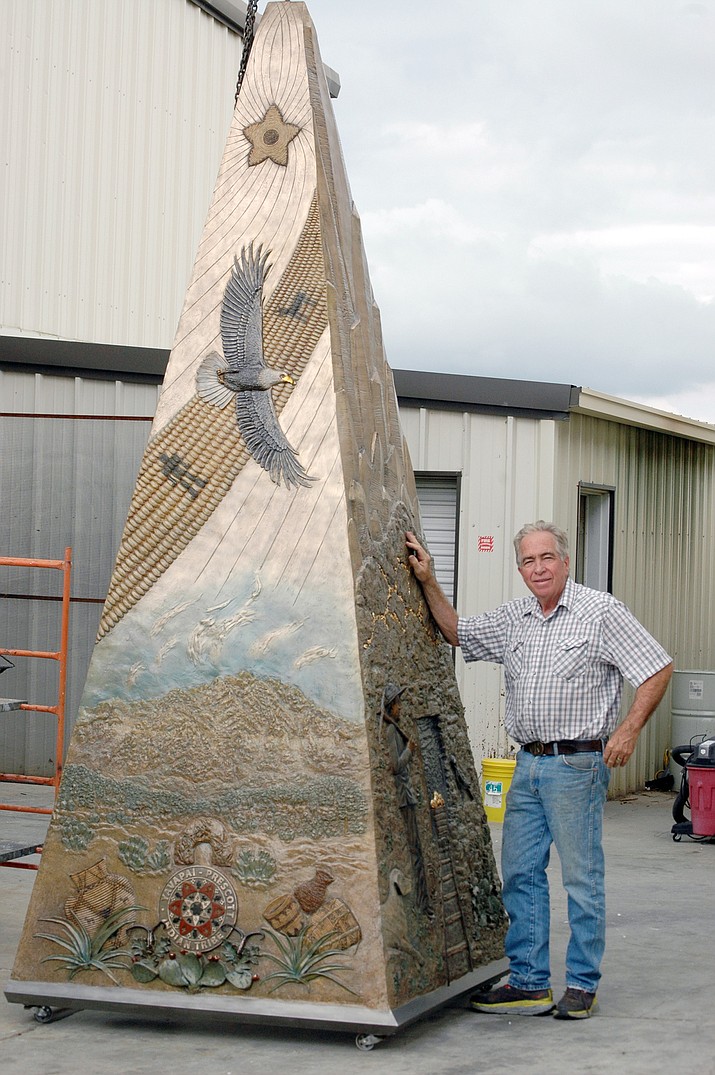 Prescott Valley-based bronze sculptor Ed Reilly stands beside the Jenkins Obelisk, which he designed and built for the Town of Prescott Valley during the past year. The monument will be erected later this month at the southwest corner of Lakeshore Drive and Skoog Boulevard at the Civic Center. (Doug Cook/Tribune)