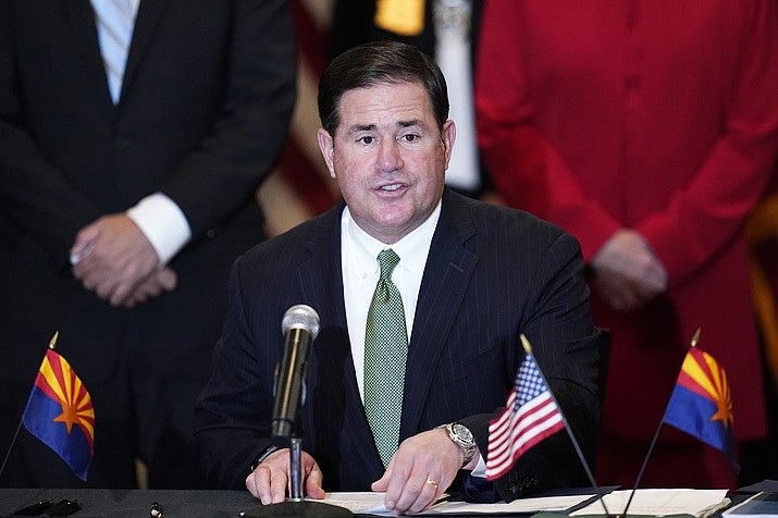 Arizona Republican Gov. Doug Ducey speaks during a bill signing in Phoenix in April. On Aug. 17, 2021, Ducey upped the pressure on the growing number of public school districts defying a state ban on face mask mandates as they try to slow the spread of the coronavirus. (AP Photo/Ross D. Franklin, File)