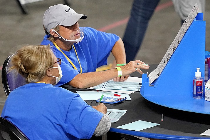 Maricopa County ballots cast in the 2020 general election are examined and recounted by contractors working for Florida-based company, Cyber Ninjas, Thursday, May 6, 2021 at Veterans Memorial Coliseum in Phoenix. (Matt York/AP, Pool)