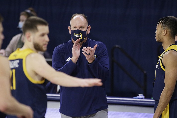 In this Monday, Dec. 28, 2020 photo, NAU coach Shane Burcar encourages his players during the second half of an NCAA game against Gonzaga in Spokane, Wash. (Young Kwak/AP, File)