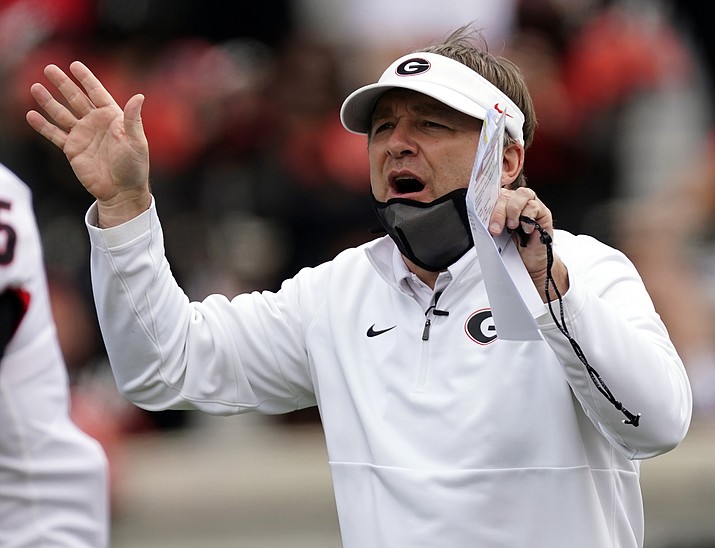 In this April 17, 2021, photo, Georgia head coach Kirby Smart talks to his players before the team's spring NCAA game in Athens, Ga. Smart, the coach of No. 5 Georgia, faces No. 3 Clemson in the season-opener in Charlotte, N.C. (John Bazemore/AP, File)