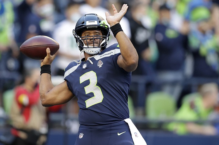 Seattle Seahawks quarterback Russell Wilson warms up for the team's NFL preseason game against the Los Angeles Chargers, Saturday, Aug. 28, 2021, in Seattle. (John Froschauer/AP)