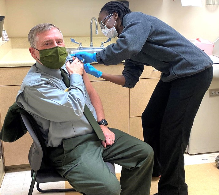 Grand Canyon Superintendent Ed Keable receives his COVID-19 vaccine from Janet Bawcom in March at the Grand Canyon Clinic. (Photo/NPS)