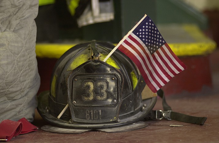 A fireman’s helmet with an American flag in it on Sept. 15, 2001, after the Sept. 11 terrorist attacks on the World Trade Center in New York City. In effort to honor the 412 emergency workers who died after responding to the World Trade Center on Sept. 11, 2001, Verde Valley first responders plan to host a “9-11 Remembrance Walk” on Saturday, Sept. 11, 2021. (Robert F. Bukaty/AP, file)