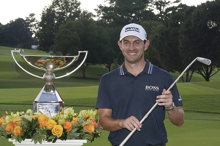 Patrick Cantlay poses with the trophies after winning the Tour Championship tournament and the FedEx Cup at East Lake Golf Club, Sunday, Sept. 5, 2021, in Atlanta. (Brynn Anderson/AP)