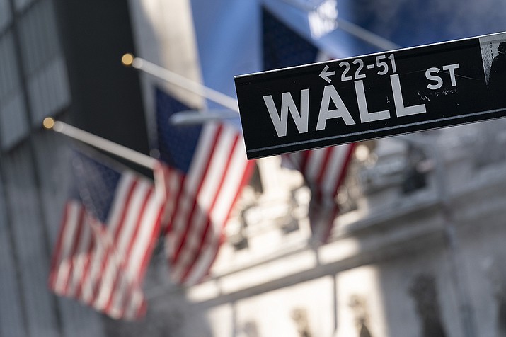 A sign for Wall Street hangs in front of the New York Stock Exchange, July 8, 2021. Stocks are off to a mostly lower start on Wall Street Friday, Sept. 17, as the market heads for a weak ending to an up-and-down week of trading. (Mark Lennihan, AP file)