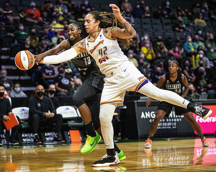 Phoenix Mercury's Brittney Griner (42) and Seattle Storm's Ezi Magbegor chase down the ball under the Storm net in the first quarter of a game Friday, Sept. 17, 2021, in Everett, Wash. (Dean Rutz/The Seattle Times via AP, File)