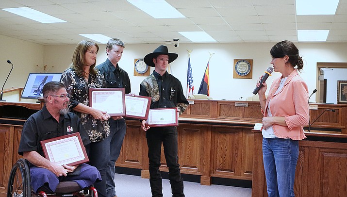 From left, Dave, Paula, Wyatt and Nathanial Pizinger accept their certificates of recognition from Council Member Annie Perkins during a Chino Valley Town Council meeting on Tuesday, Sept. 14, 2021. The family was recognized for their volunteer work in the community, especially in the effort to revitalize the 9/11 memorial sculpture in Chino Valley. (Town of Chino Valley/Courtesy)