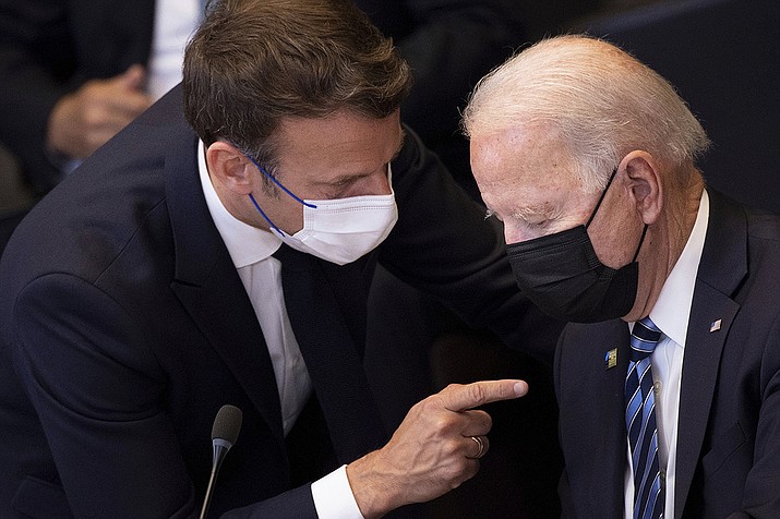 In this June 14, 2021 file photo, U.S. President Joe Biden, right, speaks with French President Emmanuel Macron during a plenary session during a NATO summit at NATO headquarters in Brussels. French President Emmanuel Macron expects "clarifications and clear commitments" from President Joe Biden in a call to be held later on Wednesday to address the submarines' dispute, Macron's office said. (Brendan Smialowski, Pool via AP, File)