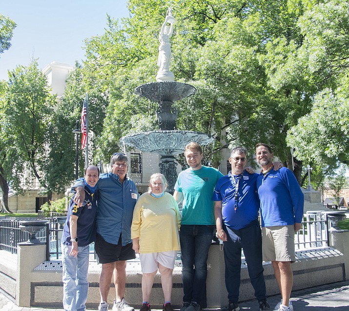 In this undated photo, the Yavapai Exceptional Industries group stands in front of the fountain located on the Yavapai County Courthouse plaza after an outing of picking out the coins that people toss into the water on a regular basis. (Yavapai County/Courtesy)