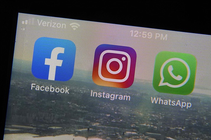 This photo shows the mobile phone app logos for, from left, Facebook, Instagram and WhatsApp in New York, Tuesday, Oct. 5, 2021. The six-hour outage was a headache for many casual users but far more serious for the millions of people worldwide who rely on the social media sites to run their businesses or communicate with relatives, fellow parents, teachers or neighbors. (Richard Drew/AP)