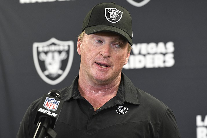 In this Sept. 19, 2021 photo, Las Vegas Raiders head coach Jon Gruden meets with the media following an NFL football game against the Pittsburgh Steelers in Pittsburgh. Gruden is out as coach of the Raiders after emails he sent before being hired in 2018 contained racist, homophobic and misogynistic comments. A person familiar with the decision said Gruden is stepping down after The New York Times reported that Gruden frequently used misogynistic and homophobic language directed at Commissioner Roger Goodell and others in the NFL. (Don Wright/AP, File)