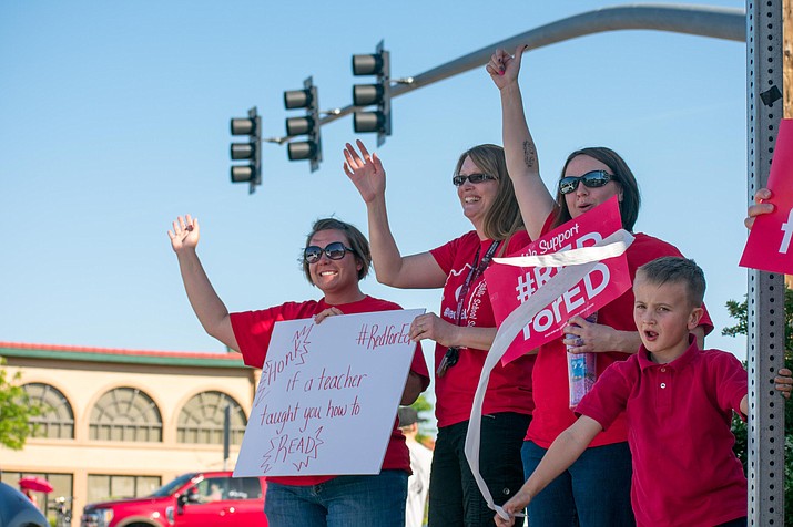 In this 2018 file photo, Mingus Union High School teacher Trecia Taylor and her son Max (right) rally along the intersection of State Route 89A and State Route 260 in support of Red for Ed. A new survey has revealed that Arizona schools were only able to fill one of five teacher vacancies for 2021-22. (Independent file photo)