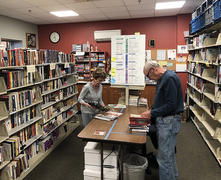 Book Sale volunteers Diane Vale and Bill Brown process books for the book sale. (Prescott Public Library/Courtesy)