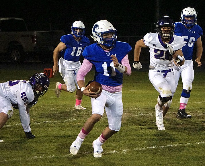 Chino Valley quarterback Jayden Smith (11) runs the ball during a game against Wickenburg on Thursday, Oct. 14, 2021, at Cougar Stadium in Chino Valley. The Cougars lost to the Wranglers 26-13. (Aaron Valdez/Courier)