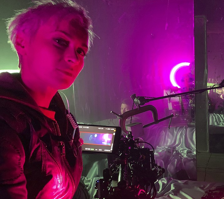 This photo shows cinematographer Halyna Hutchins on the set of "Archenemy" in January 2020 in Los Angeles. Hutchins was fatally shot by Alec Baldwin Thursday, Oct. 21, 2021, on the New Mexico set of the western film "Rust." Authorities continue to investigate the shooting but there are no allegations of wrongdoing by Baldwin. (Adam Egypt Mortimer via AP)