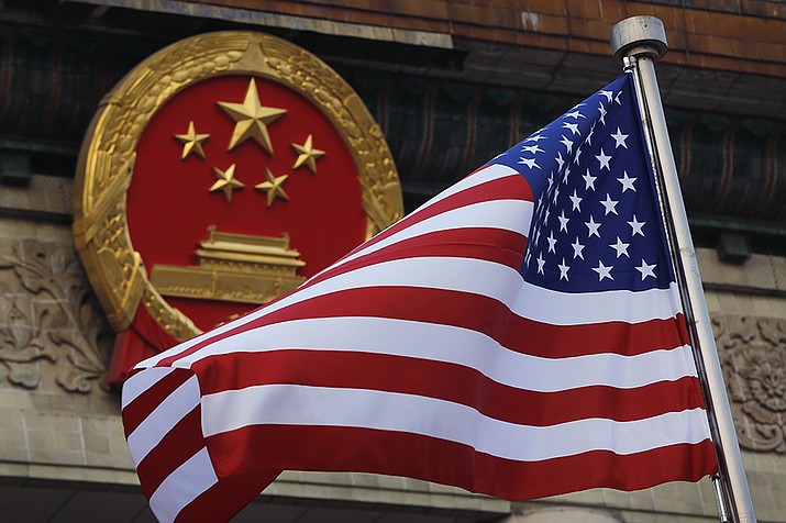 An American flag is flown next to the Chinese national emblem during a welcome ceremony for visiting U.S. officials in 2017. U.S. officials are issuing new warnings about China’s ambitions in artificial intelligence and a range of advanced technologies that could eventually give Beijing a decisive military edge and possible dominance over health care and other essential sectors in America. (Andy Wong, AP File)