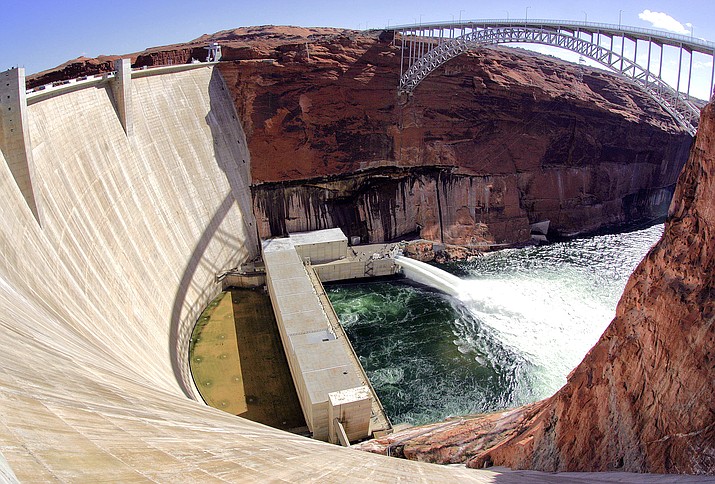 Water flows from the number one and two jet tubes as seen from atop the Glen Canyon Dam in 2008 in Page, Ariz. The U.S. Bureau of Reclamation decided against sending water rushing through the Grand Canyon this fall to redeposit sediment because of persistent drought. Agency officials said opening the bypass tubes at the Glen Canyon Dam would have reduced the elevation of Lake Powell at a time when it’s at historic lows. (AP Photo/Matt York, File)