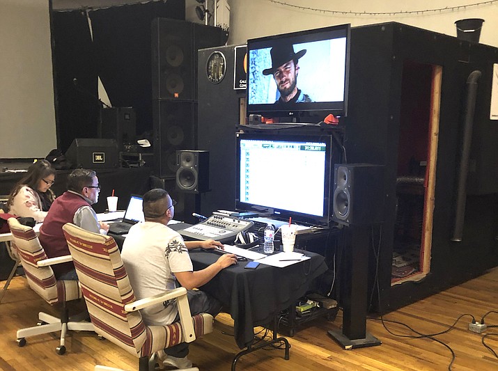 Jennifer Jackson-Wheeler, from left, Joe H. Kee, and Hawk Sequra work on the Navajo dubbing of the iconic Western film, "A Fistful of Dollars," at Native Stars Studio in Gallup, New Mexico in 2019. The film is the third major flick available in the Navajo language. (Manuelito "Manny" Wheeler/Navajo Nation Museum via AP)