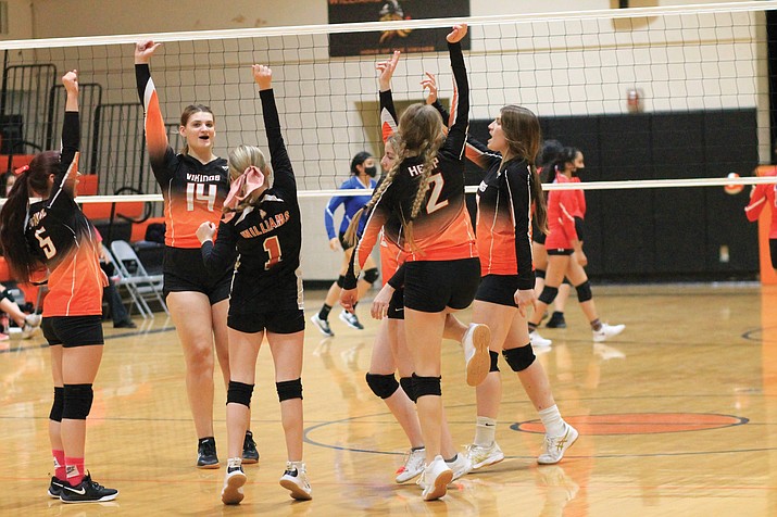 Vikings volleyball players celebrate in an earlier season game. (Wendy Howell/WGCN)
