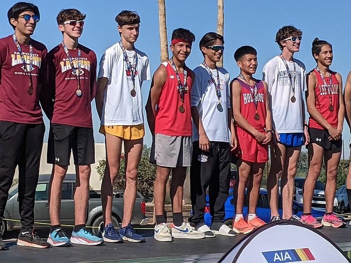 Cesar Diaz, center, red shirt, smiles for the camera after receiving his medal for first place overall in the Division III race at the AIA Cross-Country State Championships on Saturday, Nov. 13, 2021, in Phoenix. (Dan Engler/Courtesy)