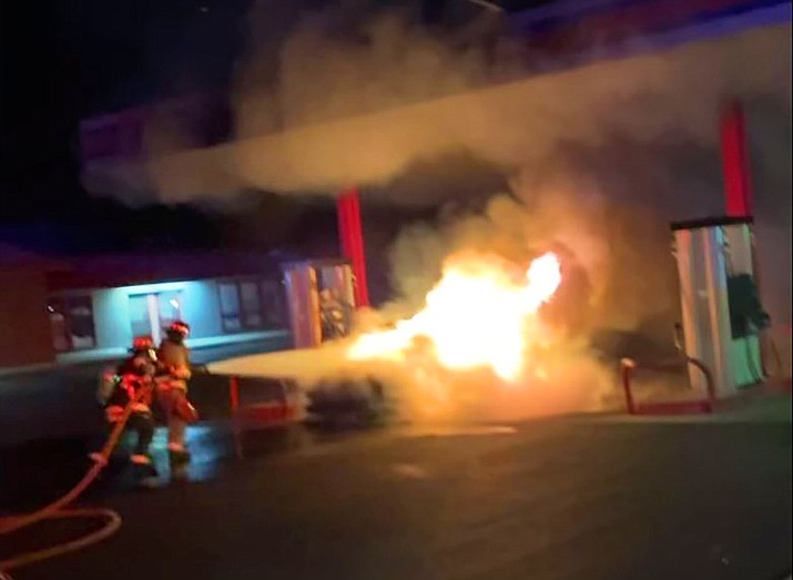 Two Verde Valley Fire District firefighters attack a car fire next to a gas pump in the Verde Village early Sunday morning, Nov. 14, 2021. (Video screenshot)
