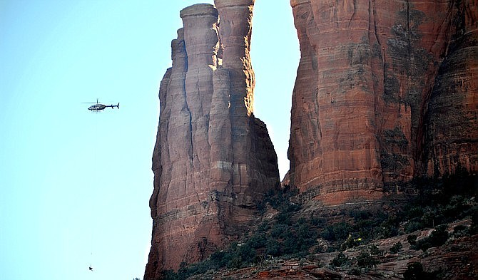This 2018 file photo shows a helicopter rescuing a stranded hiker. The Yavapai County Sheriff’s Office Search and Rescue teams were needed to rescue two sets of hikers Nov. 6 and 7. (Vyto Starinskas/Independent, file)