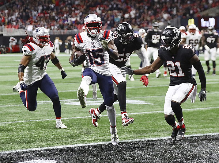 New England Patriots wide receiver Nelson Agholor high steps into the end zone for a touchdown past Atlanta Falcons defenders Brandon Copeland, center, and Duron Harmon for a 10-0 lead during the second quarter of an NFL football game on Thursday, Nov. 18, 2021, in Atlanta. (Curtis Compton/Atlanta Journal-Constitution via AP)