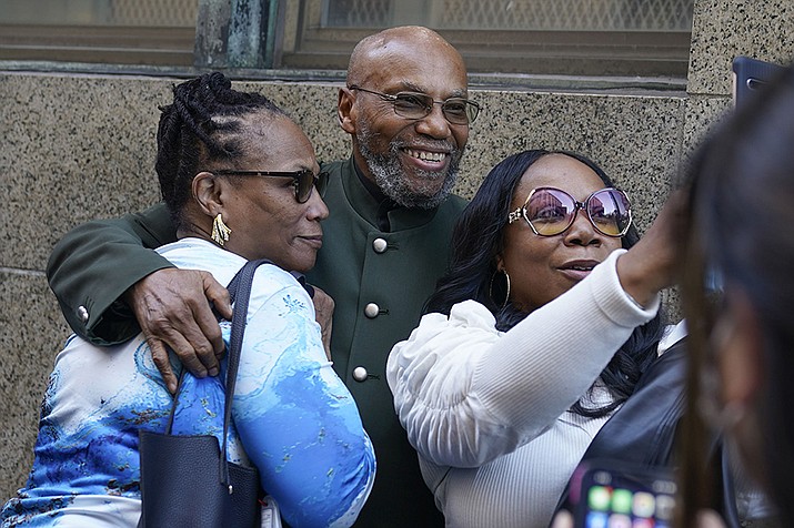 Muhammad Aziz, center, stands outside the courthouse with members of his family after his conviction in the killing of Malcolm X was vacated, Thursday, Nov. 18, 2021, in New York. A Manhattan judge dismissed the convictions of Muhammad Aziz and the late Khalil Islam, after prosecutors and the men's lawyers said a renewed investigation found new evidence that the men were not involved with the killing and determined that authorities withheld some of what they knew. (Seth Wenig/AP)