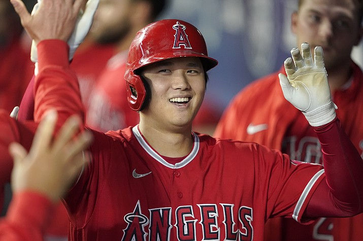 Los Angeles Angels' Shohei Ohtani is greeted in the dugout after he hit a solo home run during the first inning of a game against the Seattle Mariners, Sunday, Oct. 3, 2021, in Seattle. On Thursday, Nov. 18, 2021, Ohtani was unanimiously voted American League MVP for a two-way season not seen since Babe Ruth. (Ted S. Warren/AP, File)