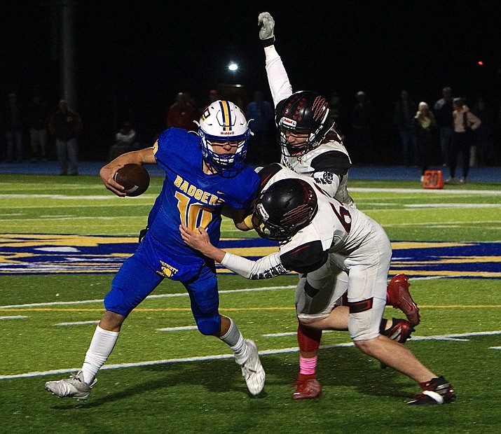 Prescott quarterback Jaxon Rice (10) fends of the defense while running the ball during a first-round game of the state playoffs against Bradshaw Mountain on Friday, Nov. 19, 2021, at Bill Shepard Field in Prescott. (Aaron Valdez/Courier)