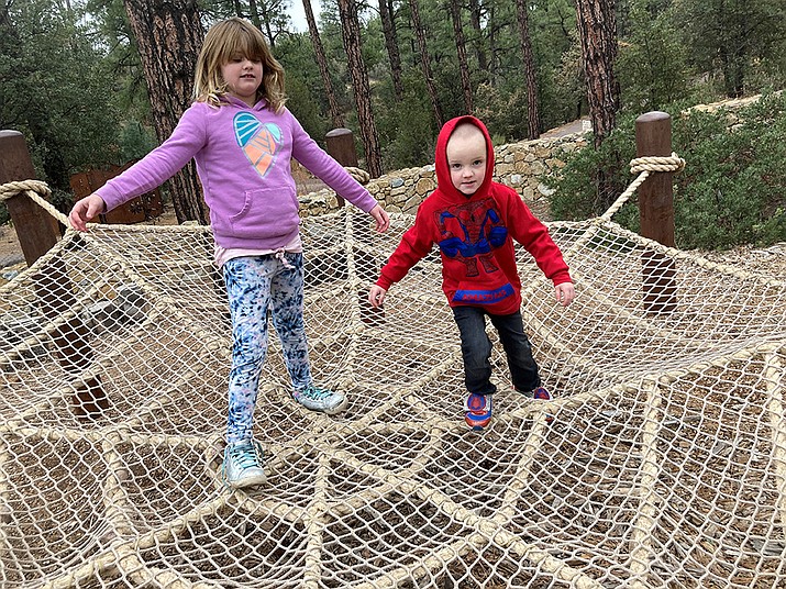 Savannah and Noah Nicholson of Kingman play on the Giant Spider Web rope play area in the “Discovery Gardens” at The Highlands Center for Natural History on Tuesday, Nov. 23.