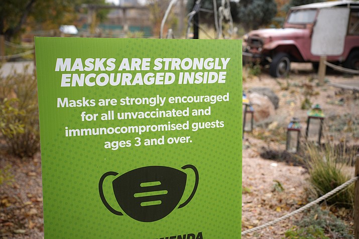 A sign encourages visitors to wear face coverings while visiting exhibits at the Denver Zoo, on Nov. 2, 2021. The U.S. is in better shape approaching its second Thanksgiving in a pandemic, thanks to vaccines, though some regions are reporting torrents of COVID-19 cases that could get even worse in the days ahead as eager families travel the country for overdue gatherings that were impossible a year ago. (David Zalubowski/AP, File)