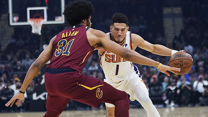 Phoenix Suns' Devin Booker (1) drives on Cleveland Cavaliers' Jarrett Allen (31) during the first half of an NBA basketball game Wednesday, Nov. 24, 2021, in Cleveland. (Tony Dejak/AP)