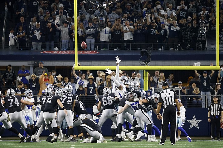 Fans look on as Las Vegas Raiders' Daniel Carlson (2) kicks a game-winning field goal in overtime of an NFL football game against the Dallas Cowboys in Arlington, Texas, Thursday, Nov. 25, 2021. (Ron Jenkins/AP)